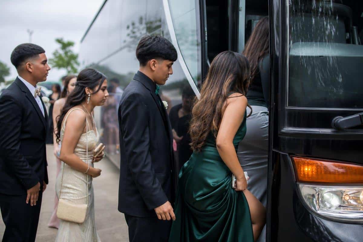 prom limo bus rental in Balch Springs TX with students boarding a motorcoach