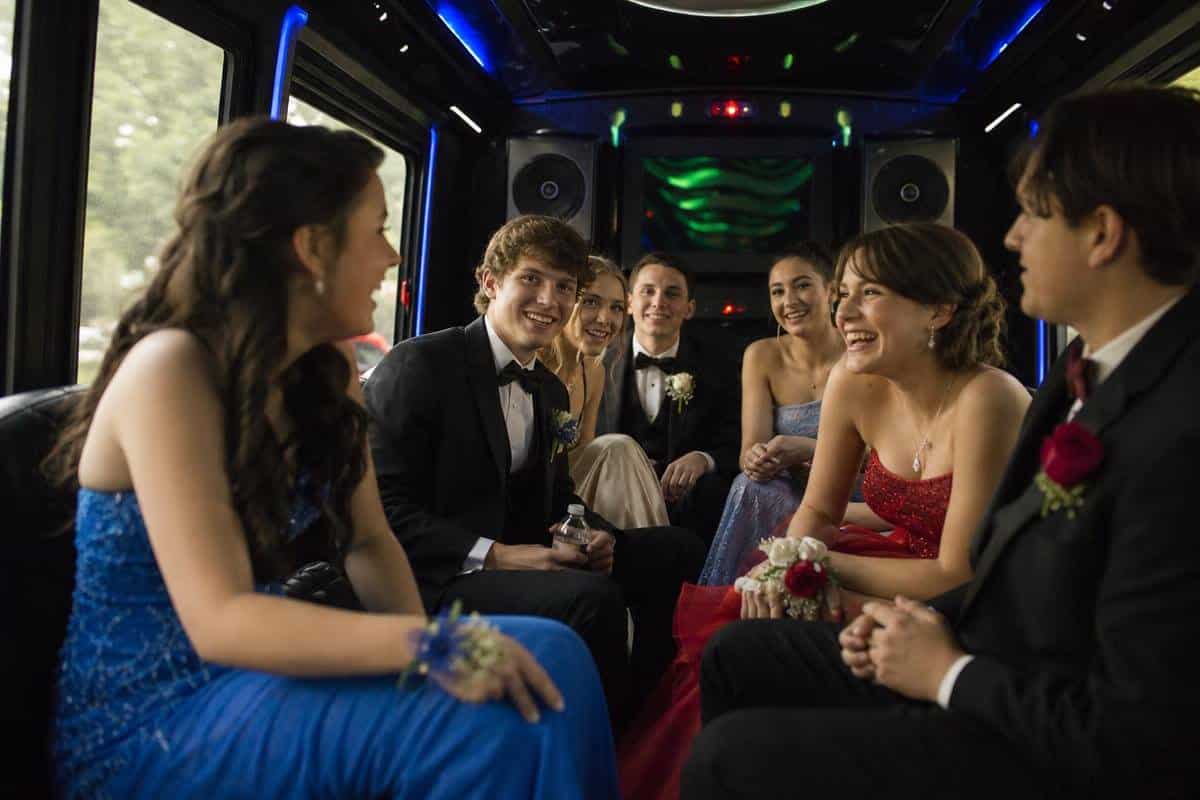 prom limo bus interior with LED lighting and bench seating for high school prom party bus rental